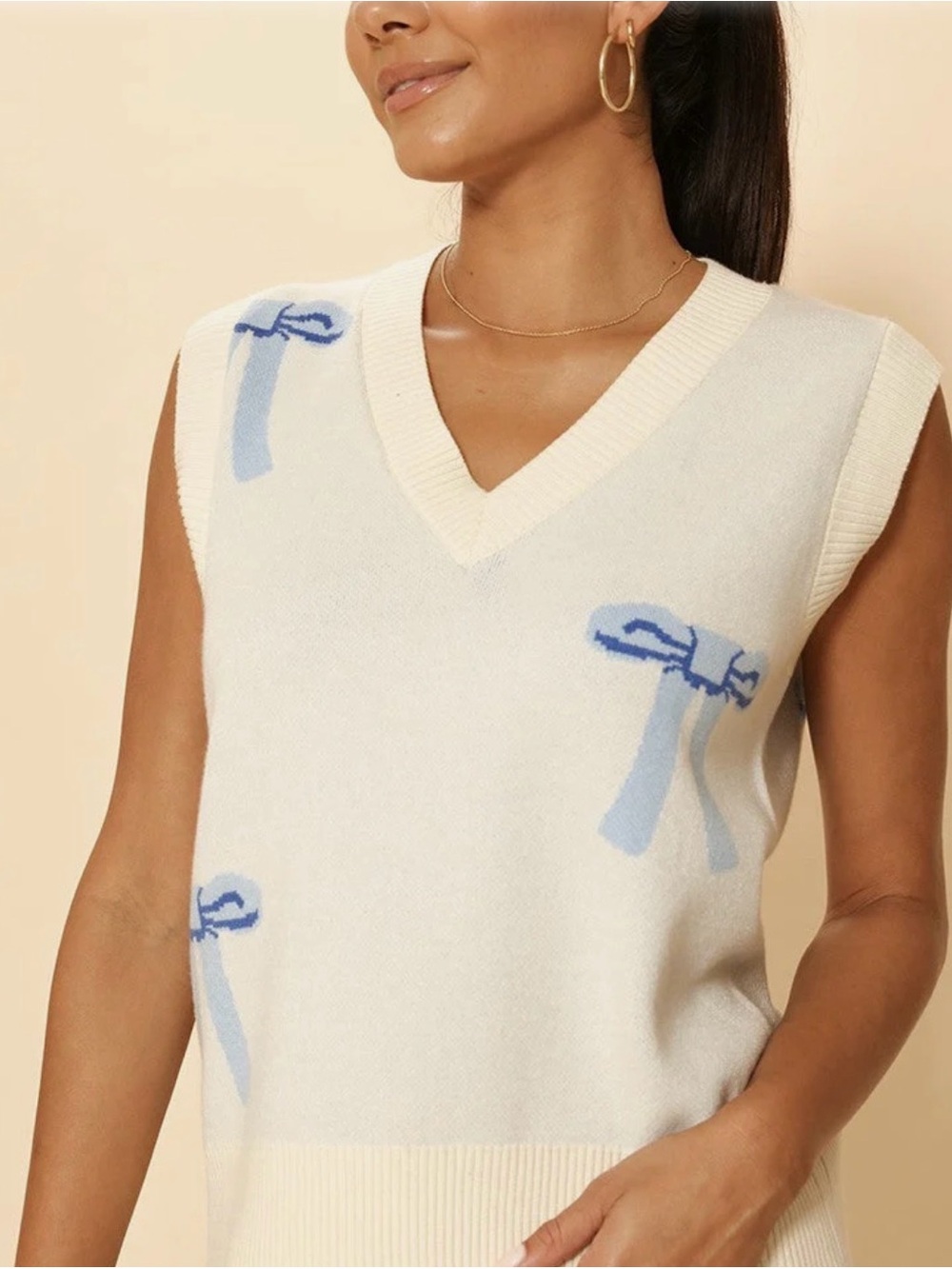 Sleeveless Ivory V-Neck Sweater Vest with Light Blue Bow Motif